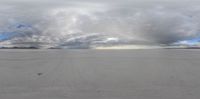 there are some clouds over the empty desert area by the ski lift lift deck of a train