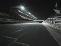 empty stadium in night with empty floor and street lights up above the field, as well as overhangs