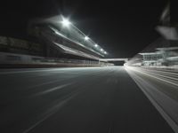 empty stadium in night with empty floor and street lights up above the field, as well as overhangs