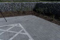 a stone wall with a white line of arrows on it is in the background of another structure