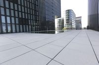 a very tall glass building with many windows on top of it's roof line