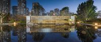 an art installation at dusk next to a pond in the city of beijing at twilight