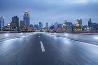 an asphalt road in a city at dusk with a blue sky background, with blurry images,