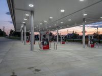 a photo of the gas station's exterior at dusk with sky in the background