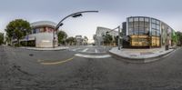 an 360 - view panoramic photo of a bus stop at dusk on a street in the town