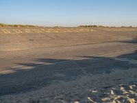 the sign is marked in yellow on a deserted runway at an airport by a beach