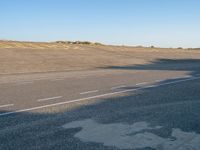 a man skateboarding on a street with a shadow on the pavement that says life