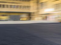 a blurry photograph of an urban area with buildings and a person riding a bike