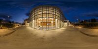 a fish eye view of a modern glass building by night time photography by david wilson