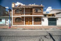 a very pretty nice house with some windows and two doors on a nice day in town