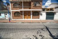 a very pretty nice house with some windows and two doors on a nice day in town