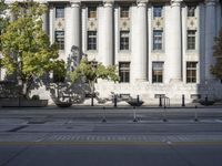 the city hall has columns and marble pillars on it, making for an elegant building