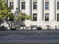 the city hall has columns and marble pillars on it, making for an elegant building