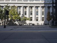 the city hall has columns and marble pillars on it, making for an elegant building