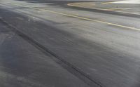 an airplane parked on the runway in front of a plane door with another car parked in the distance