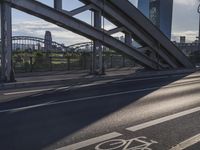 a bike lane and street name written in german on a bridge in the middle of the city