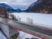 a view from above of an icy, cold valley and road over a highway on which is an open gorge