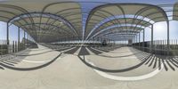 the bridge with many curves of curved metal pipes, seen from under it, with a person walking on top of it