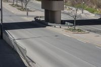 an elevated bridge on the side of a highway with cars and traffic on both sides