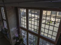 view from inside an unfinished building at daytime, outside and to the courtyard and a bus