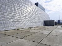 a large building with a roof made out of glass blocks is on a plain, the sky is blue