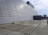 a large building with a roof made out of glass blocks is on a plain, the sky is blue