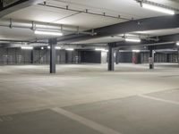 a empty parking lot, with no parking signs displayed in front of it, surrounded by metal poles and beams