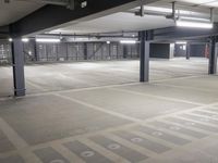 a empty parking lot, with no parking signs displayed in front of it, surrounded by metal poles and beams