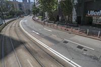 a city highway that has two lanes with no traffic and one car going on it