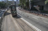 a city highway that has two lanes with no traffic and one car going on it