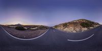 a curved mountain road with two faces as seen from one point of view and another point of view