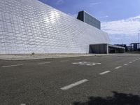 a white building with glass and metal blocks on it with no numbers for the bus riders