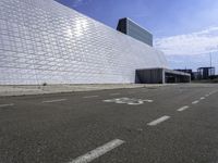 a white building with glass and metal blocks on it with no numbers for the bus riders