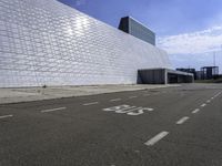 a white building with glass and metal blocks on it with no numbers for the bus riders