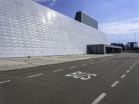 a white building with glass and metal blocks on it with no numbers for the bus riders