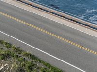 this is an aerial view of the ocean and road and motorcycle trails near the water