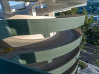 the building is winding up to the street below it and on the other side of the spiral staircase