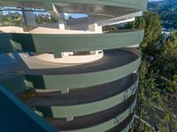 the building is winding up to the street below it and on the other side of the spiral staircase