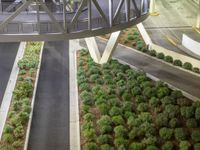 a view of a road and an overpass with traffic passing through it by buildings