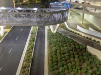 a view of a road and an overpass with traffic passing through it by buildings