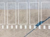 a view from above on the top of an empty parking lot, looking like someones shadow