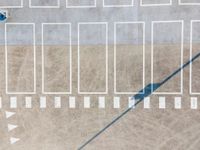 a view from above on the top of an empty parking lot, looking like someones shadow