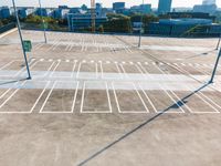 an empty parking lot with empty space on it in a city park and there are several different buildings in the background