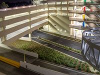 a view of a road and an overpass with traffic passing through it by buildings