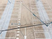 an overhead view of a parking lot near many parked cars in a commercial area of the city