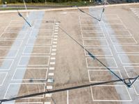 an overhead view of a parking lot near many parked cars in a commercial area of the city