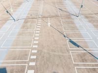 an overhead view of a parking lot near many parked cars in a commercial area of the city