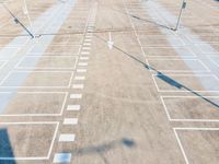 an overhead view of a parking lot near many parked cars in a commercial area of the city