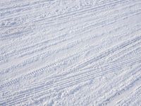 a person is in the snow riding on skis with his feet up and holding a pair of skis