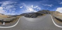 a panoramic view of a curved road going through a mountainous area in switzerland